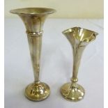 Two silver vases on raised circular bases