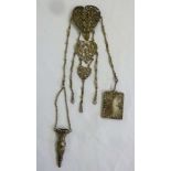 A Victorian hallmarked silver chatelaine, scroll pierced and chased with putti, Birmingham 1898