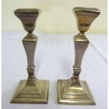 Pair of silver table candlesticks on stepped square bases, Birmingham 1946