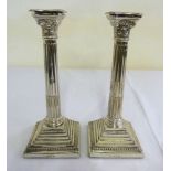 Pair of silver Corinthian column table candlesticks on stepped square bases with beaded borders,