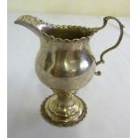 A George III silver cream jug, punch bead border on raised circular foot, London 1786