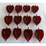 Twelve 1940s cranberry pressed glass leaf shaped bonbon dishes