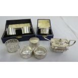 A quantity of silver to include two cased sets of napkin rings, four other napkin rings, a mustard