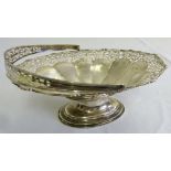 Silver bread basket, oval lobed body pierced sides and swing handle on raised oval base,