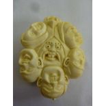 Oriental early 20th century ivory Netsuke, carved with a variety of faces with various