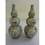 Pair of Chinese 19th century Famile Rose double gourd vases, red character marks to the bases