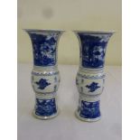 A pair of Chinese 19th century blue and white vases decorated with idealised landscapes to the