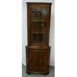 Mahogany corner cabinet, hinged glazed door on bracket feet