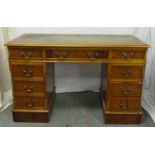 Leather top yew wood pedestal desk with eight drawers and brass handles