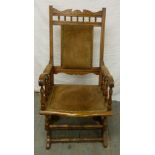 An early 20th century mahogany and leather rocking chair