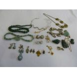 A quantity of costume jewellery to include necklaces, bracelets, brooches and charms