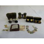 A quantity of collectables to include cufflinks, a lighter, opera glasses and a white metal charm