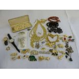 A quantity of costume jewellery to include necklaces, brooches and watches