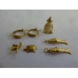 A quantity of gold jewellery to include a pair of earrings and five charms, approx total weight 17.