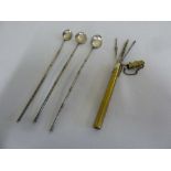 Three white metal cocktail spoons and a brass crochet hook holder with crochet hooks