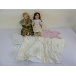 Two bisque head Armand Marseille dolls with additional dolls clothing
