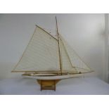 Scale model of a yacht on a wooden plinth 107cm (h) x 119cm (w)