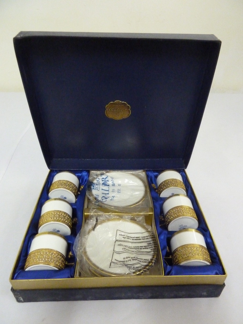 A cased set of six Coalport Elite coffee cans and saucers with gilt metal mounts