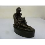 Bronze figurine of a lady and child reading a book, on raised oval plinth, signed to base