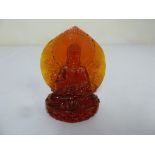 Amber carved figurine of a Buddha on oval base