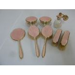 Silver and pink enamel dressing table set to include brushes, hand mirror, dressing table jars and