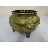 Chinese bronze jardinière with scroll pierced rim on four mask mounted legs - marks to the base