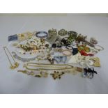 A quantity of costume jewellery to include necklaces, brooches, rings and pendants