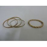 A three hoop 9ct gold bangle and another 9ct gold bangle, approx 33.7g