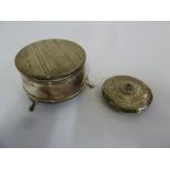 Silver jewellery box with hinged cover on three claw feet and a white metal compact