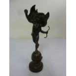 Bronze figurine of Cupid on raised circular base