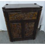 An Oriental hardwood cocktail cabinet with carved panels and hinged cover and sides