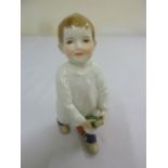 An early 20th century Meissen figurine of a boy, A/F