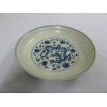 A Chinese blue and white Ming style bowl decorated to the centre with dragons