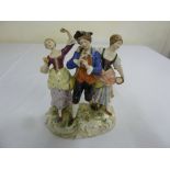 A Crown Naples porcelain figural group on naturalist base