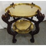 An early 20th century Oriental two tier hardwood stand with detachable engraved brass trays