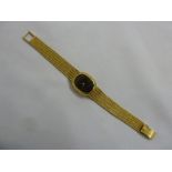 18ct gold ladies wristwatch with black onyx face and integral bracelet, approx 46.7g