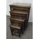 A nest of four Oriental hardwood tables with detachable glass tops