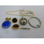 A quantity of costume jewellery to include brooches and bangles