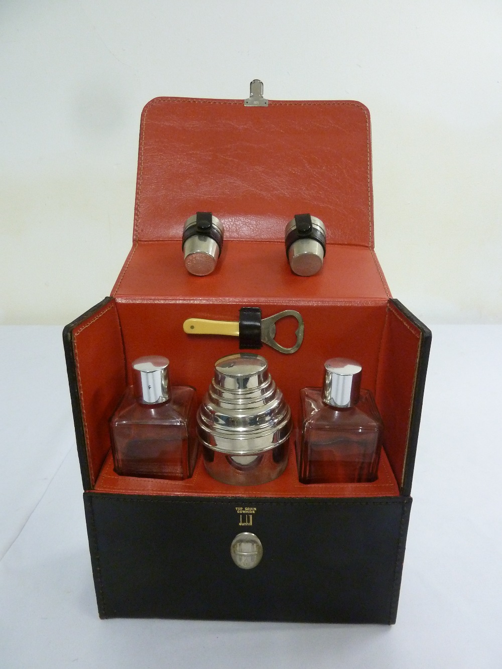 Dunhill circa 1960 leather cased cocktail set to include cocktail shaker, bottles, tot measures