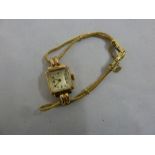 9ct gold ladies wristwatch on a gold plated bracelet