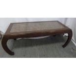 An Oriental hardwood rectangular coffee table with carved top and detachable glass