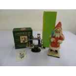 A childs toy Singer sewing machine in original packaging and a1920s figure of Father Christmas in