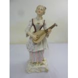 A 19th century Meissen figurine of lady strumming a lute, 46.5cm (h), A/F