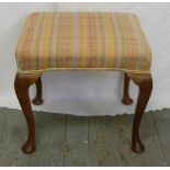 An upholstered Mahogany piano stool on four cabriole legs