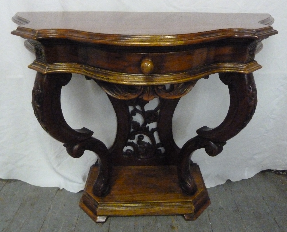 Mahogany hall table with serpentine front on carved wooden feet