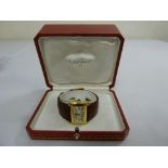 An 18ct gold Cartier tank wristwatch with burgundy leather Cartier strap, in original fitted case