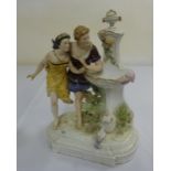 Continental porcelain group of a man and woman at a well