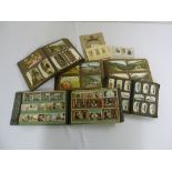 A quantity of postcards, tea and cigarette cards in albums