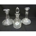 Three cut glass decanters with drop stoppers and a enamel port label