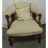 Mahogany upholstered armchair on four cabriole legs